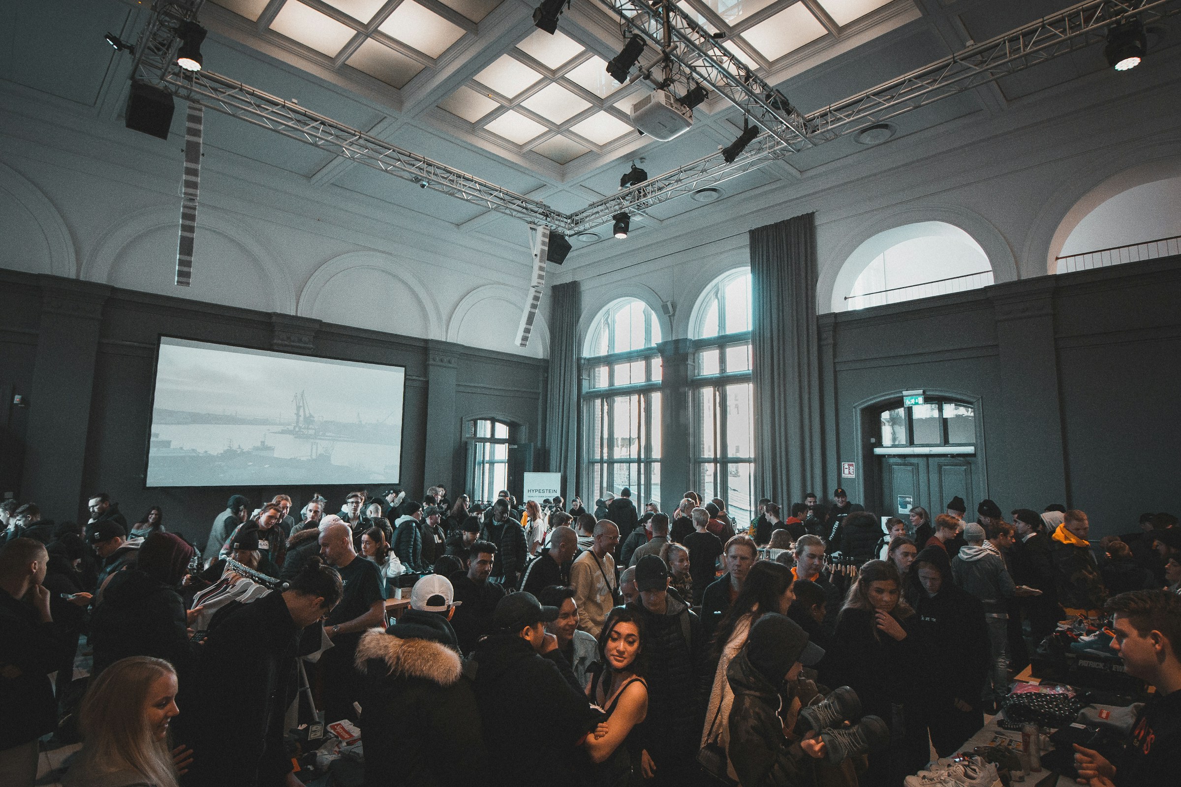 Large event hall with crowd celebrating