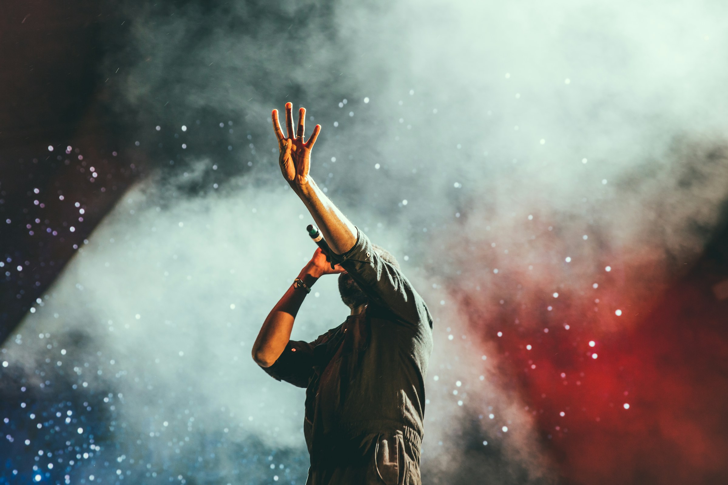 Performer on stage with theatrical smoke and lighting